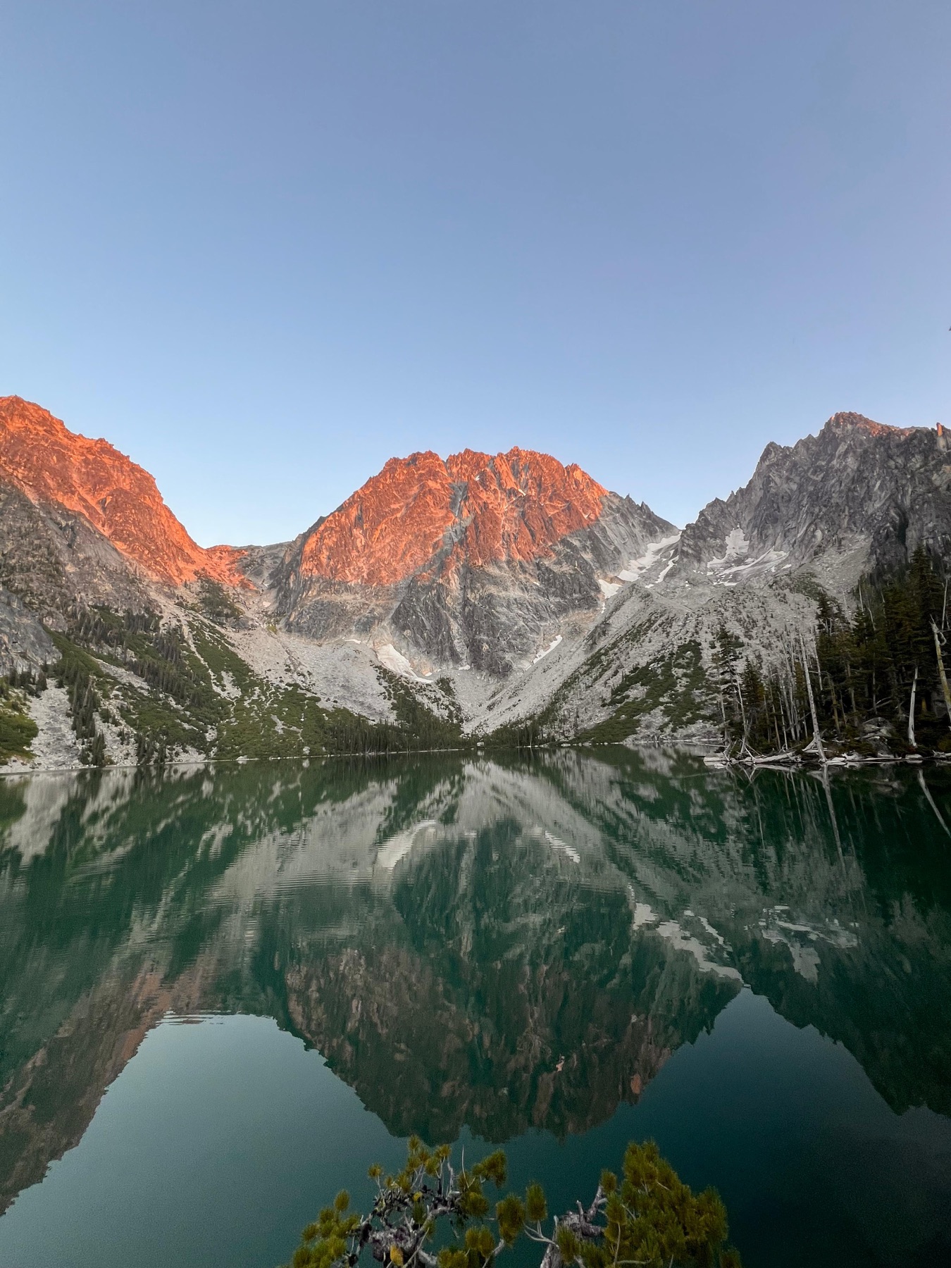 Morning alpenglow on the peaks, reflected in the lake